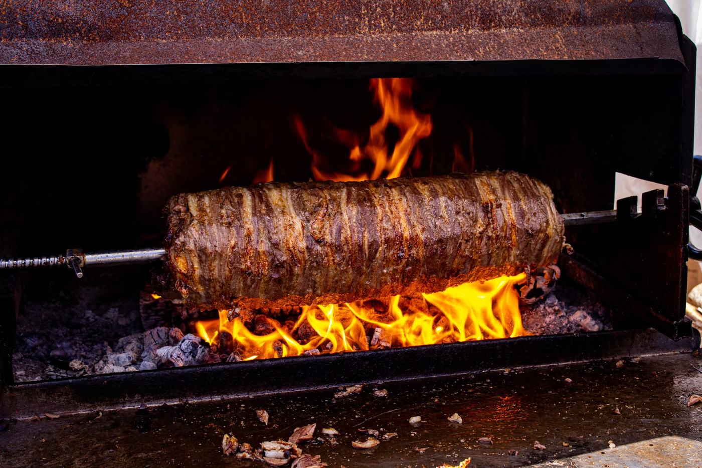 Kebabspett som grillas över öppen eld
